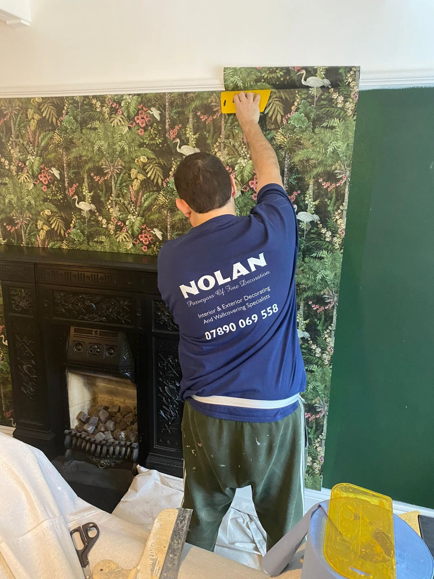 Graham hanging wallpaper - professional decorator at work in Essex