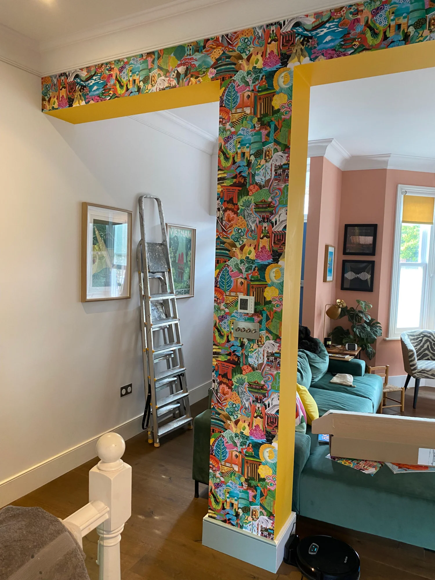 Full stairwell view showing seamless wallpaper pattern matching across angled walls