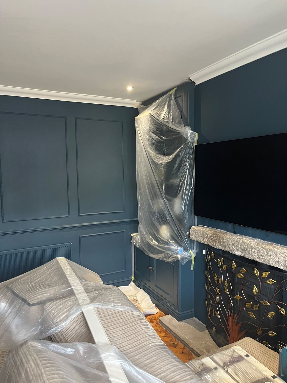 Living room with dark navy panelled walls in Rayleigh before redecoration