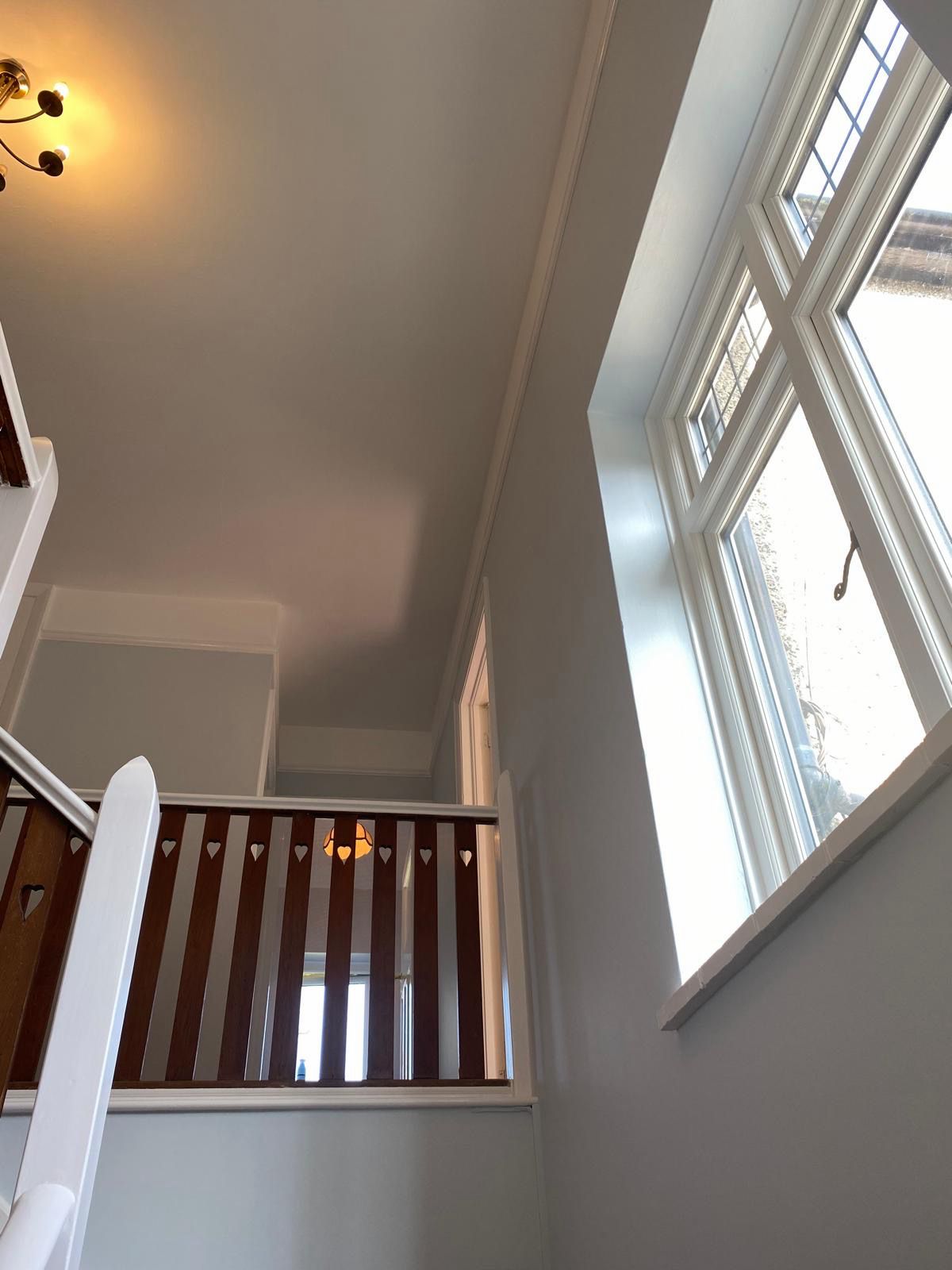 Stairwell ceiling after professional plaster repair and painting in Westcliff-on-Sea
