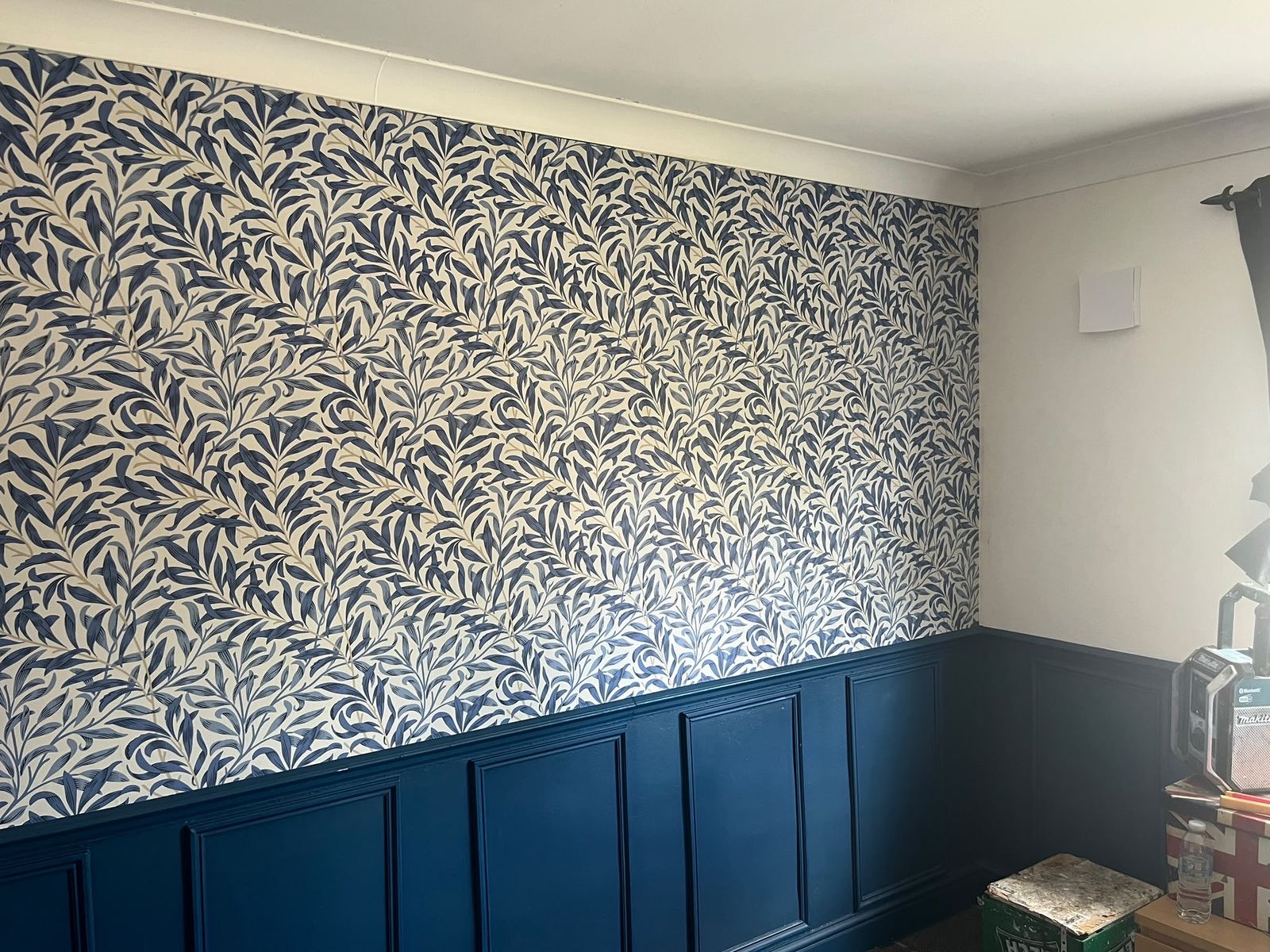 William Morris Willow Bough wallpaper hung above navy panelling in a Rayleigh home