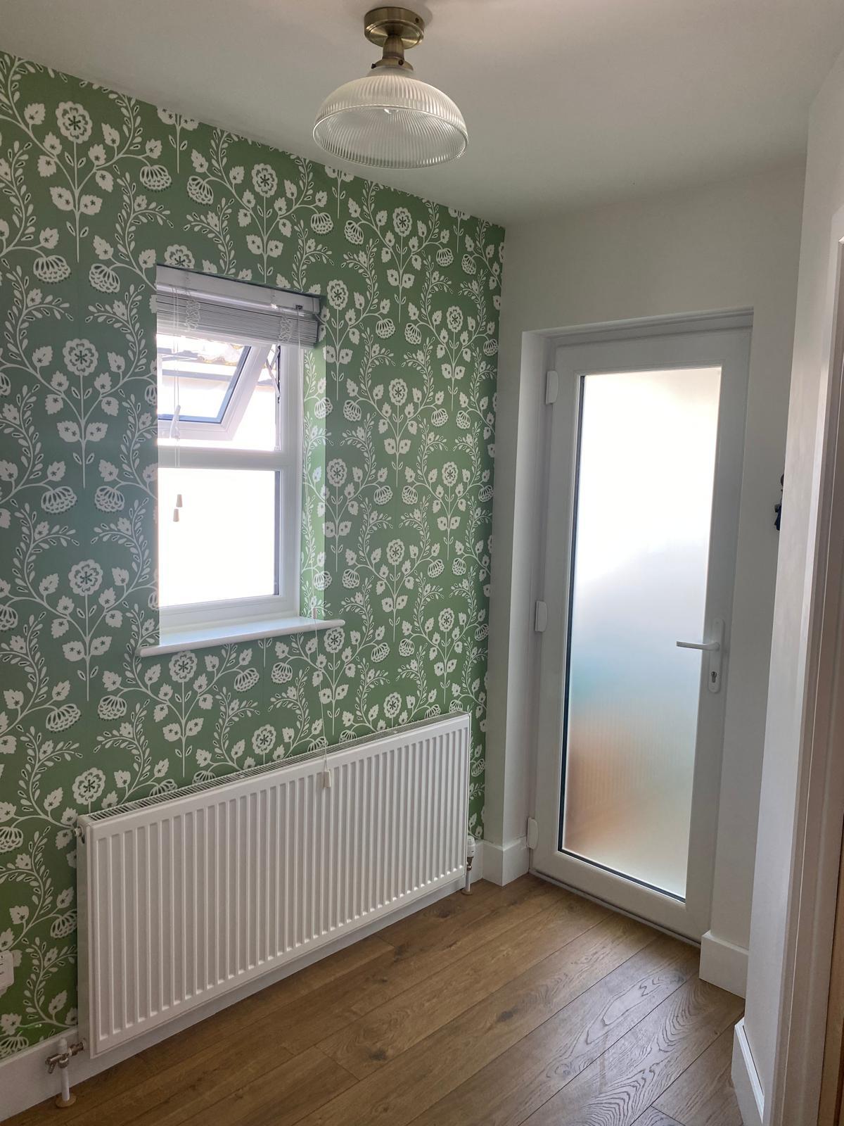 Green folk floral wallpaper installed